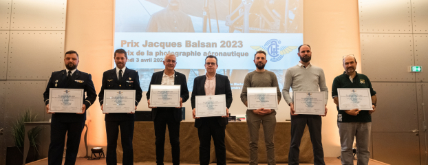 Les lauréats ayant reçu un prix dans le cadre du concours de Jacques Balsan se tiennent sur l'estrade avec leur certificat de prix